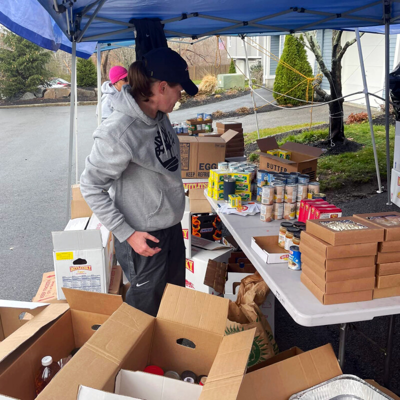 Woman unpacking boxes of donations.
