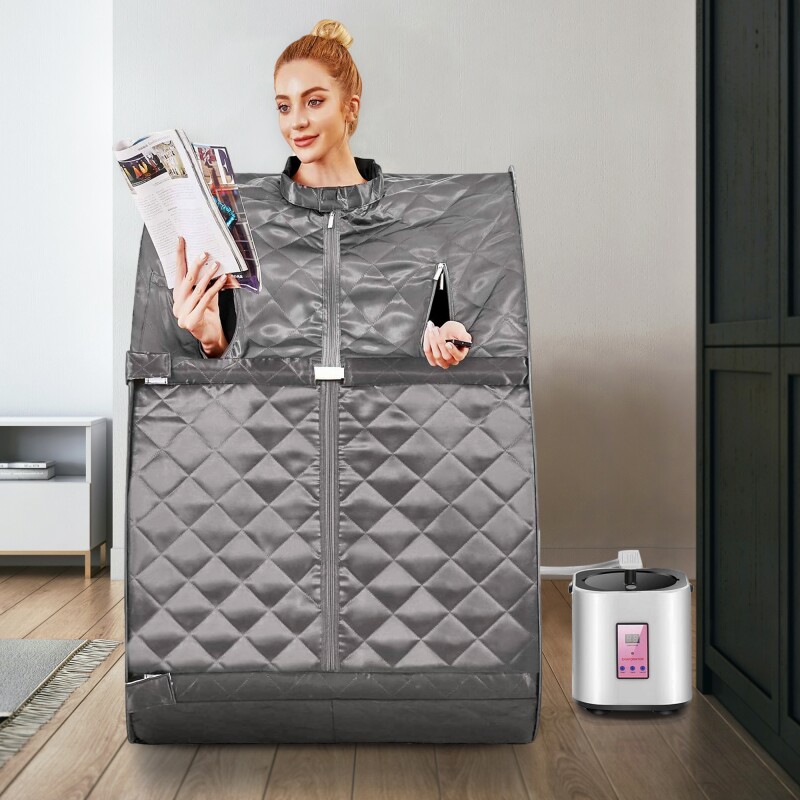 Woman sitting in grey self-contained portable sauna.