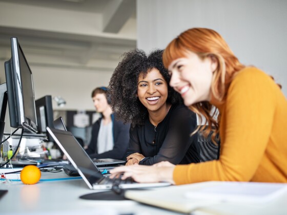 Two female colleagues in office working together