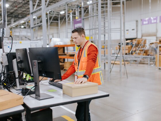 Wayfair warehouse employee on computer at furniture warehousing fulfillment center