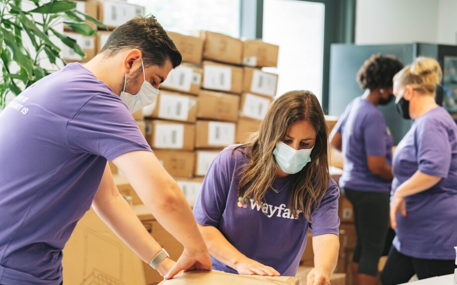 Wayfair employees unpacking furniture for the John and Jill Ker Conway Residence, a 124-unit, mixed-income home for veterans who have formerly experienced chronic homelessness and low-income residents in Washington D.C.
