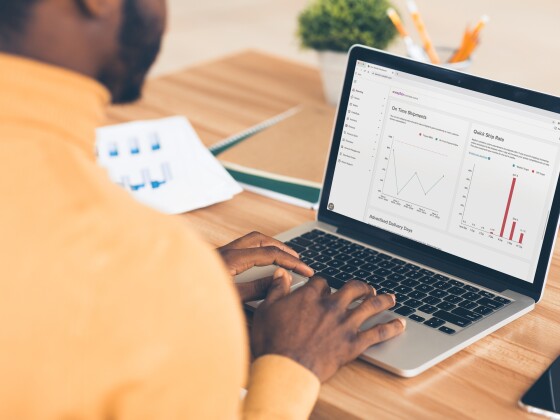 Man using laptop with graphs on the screen