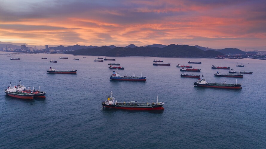 Aerial view Oil ship tanker park on the sea waiting for load or unload oil at loading dock from refinery, Business logistics, import export shipping or freight transportation.