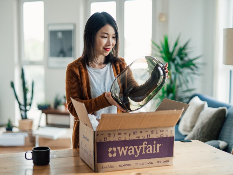 Image of woman happy with purchase from Wayfair. This can help generate reviews