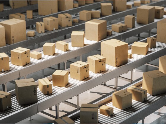 Image of shipping boxes on conveyor belts in an ecommerce fulfillment warehouse