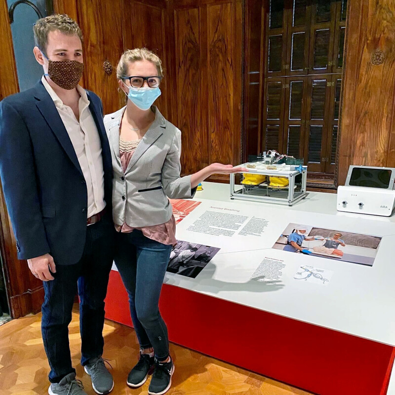 Man and woman standing in front of a display of new ventilators.