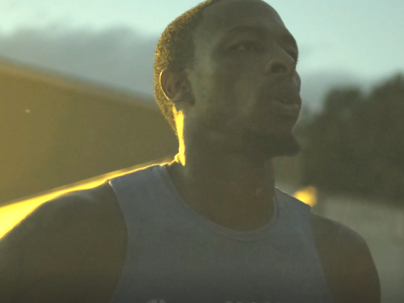 Joe Lovell, wearing a tank-top, takes a deep breath break during a workout.