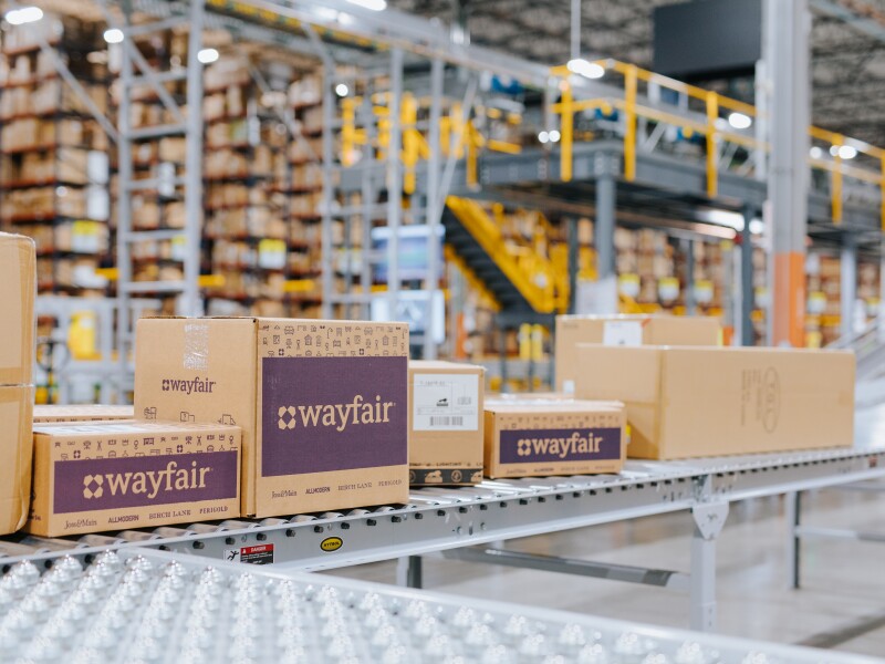Image of warehouse with Wayfair boxes on conveyor belt